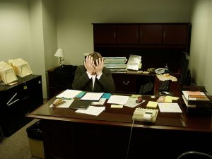 Frustrated_man_at_a_desk.jpg Author LaurMG